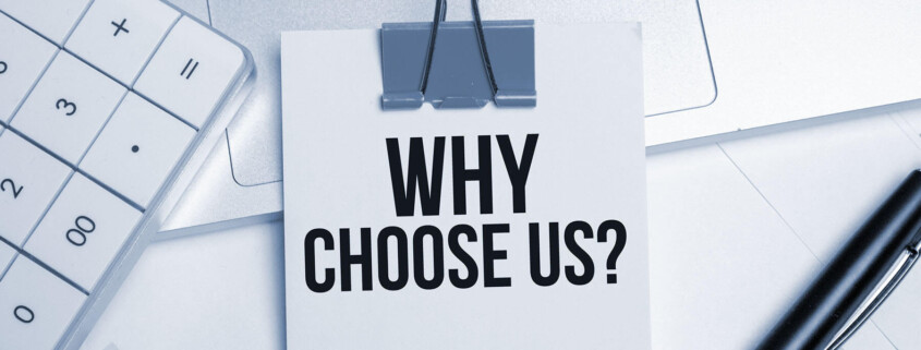 paper clip holding small note with why choose us in large print